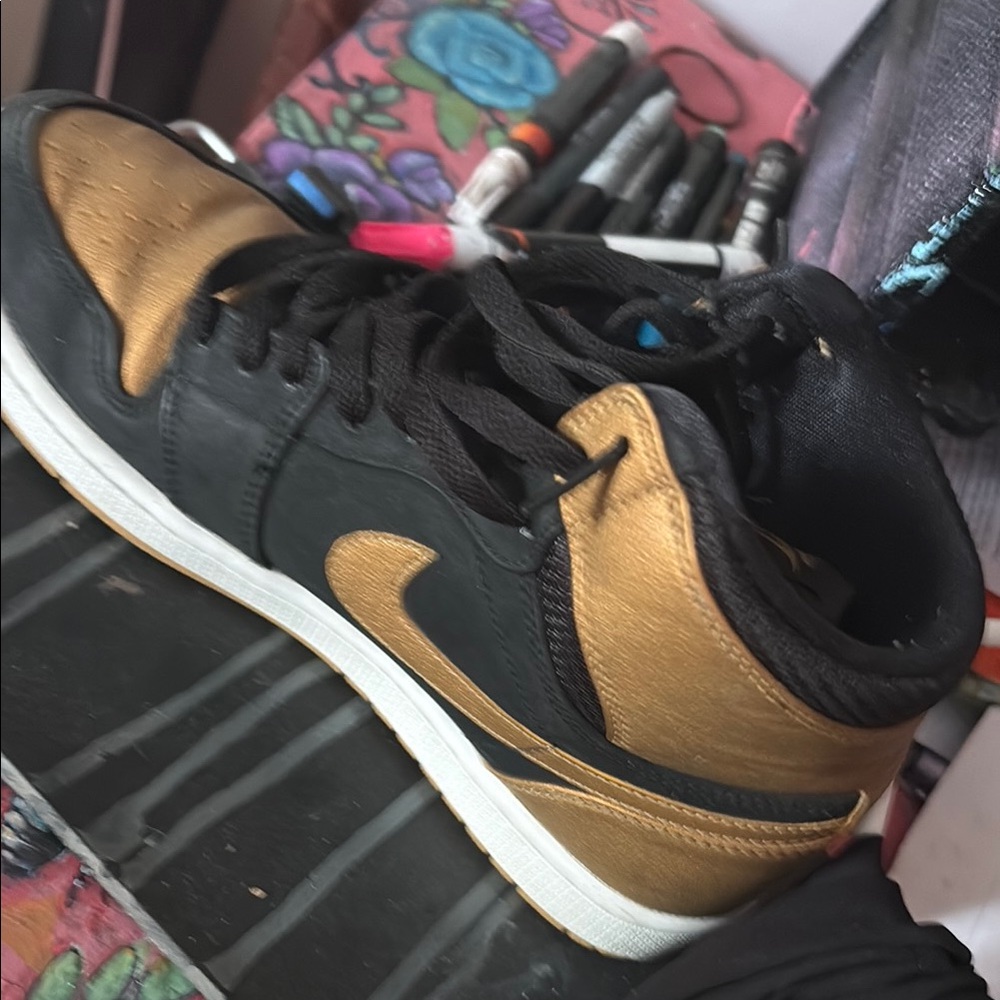 Nike Black and Gold Sneakers with Classic Silhouette